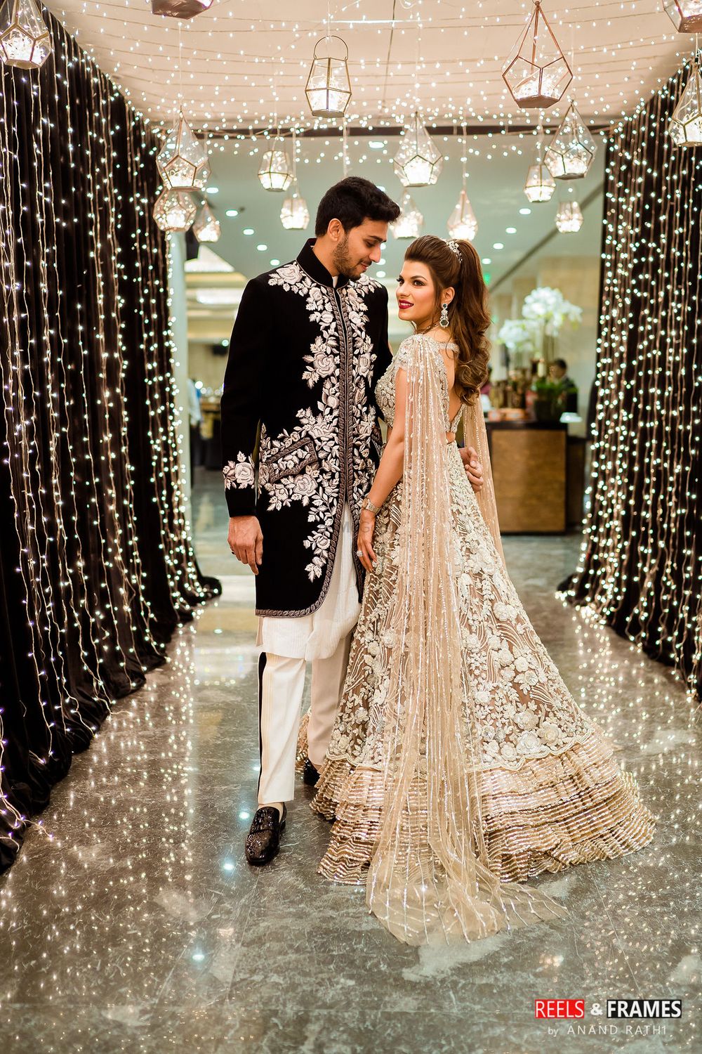 Photo of A bride and groom in coordinated clothes for their sangeet ceremony