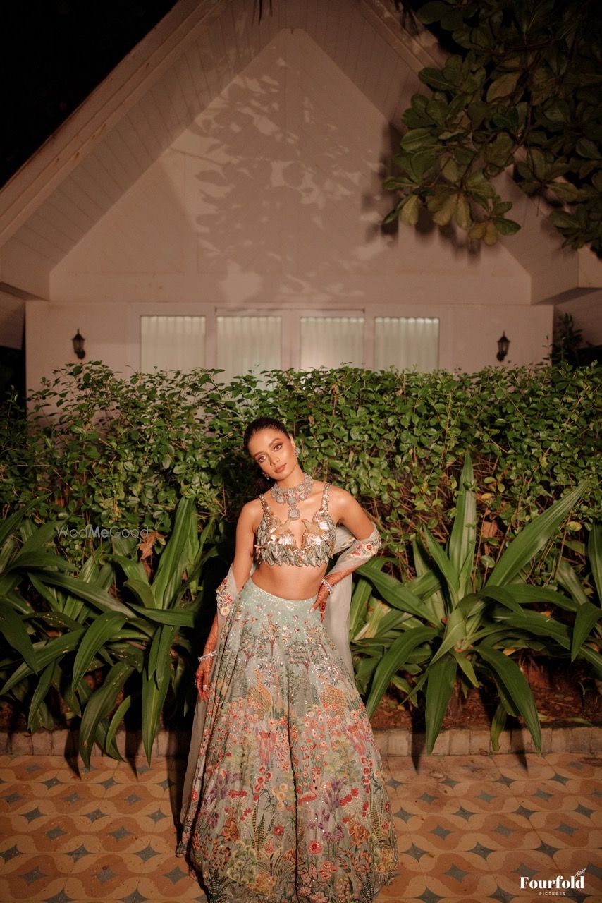 Photo of Fun ice blue lehenga with bird motifs on the blouse and floral work on the lehenga