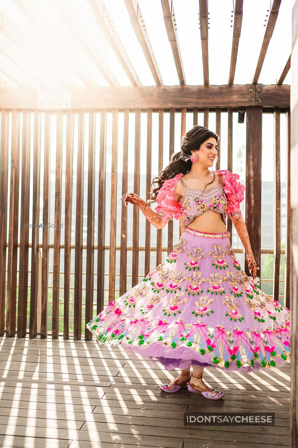 Photo of Bride twirling in a short lehenga on her mehendi.