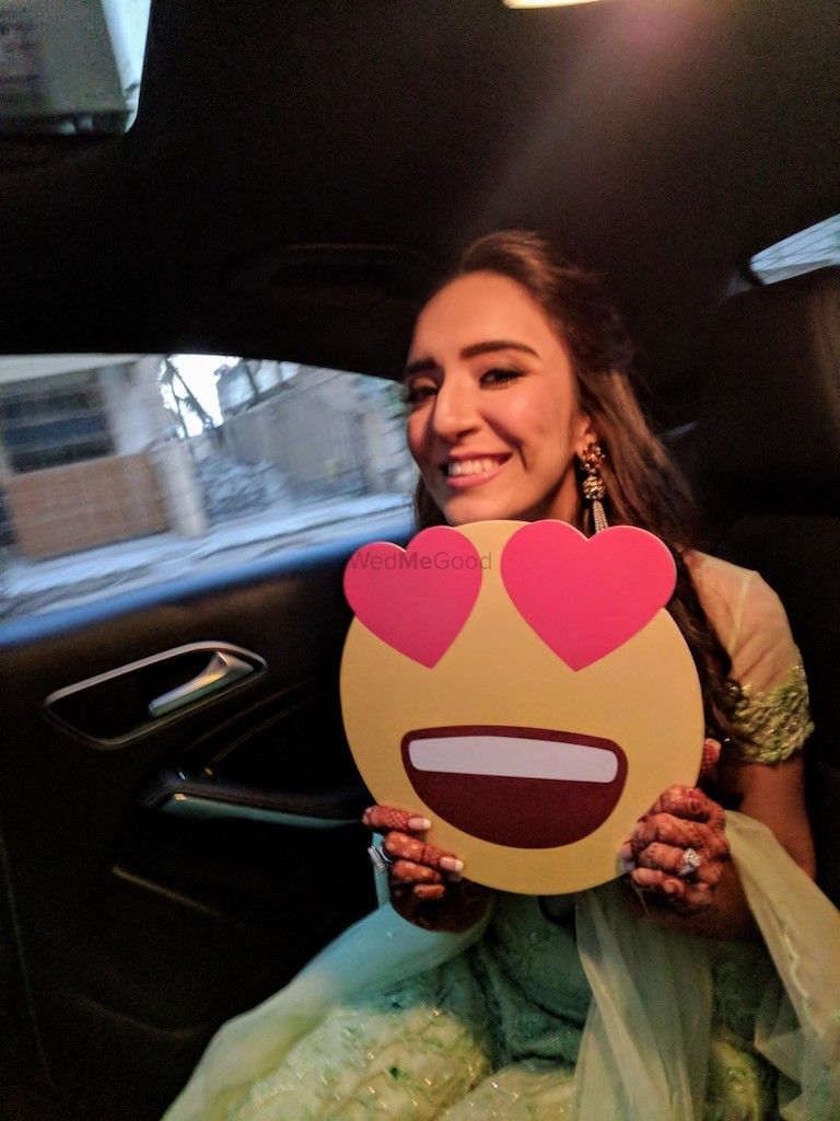 Photo of Happy bride holding smiley prop