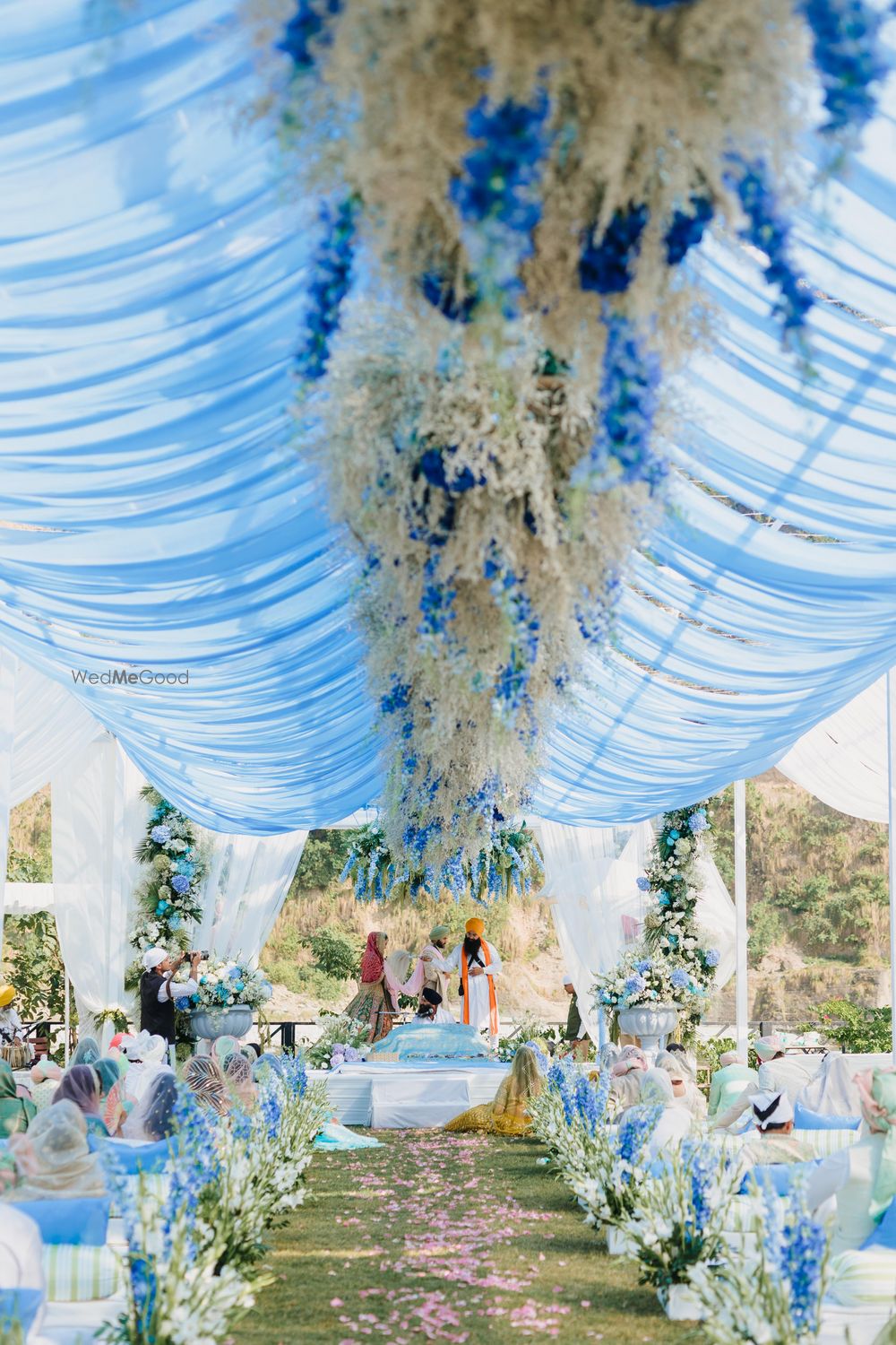 Photo of Beautiful white and blue themed floral decor for an anand karaj ceremony