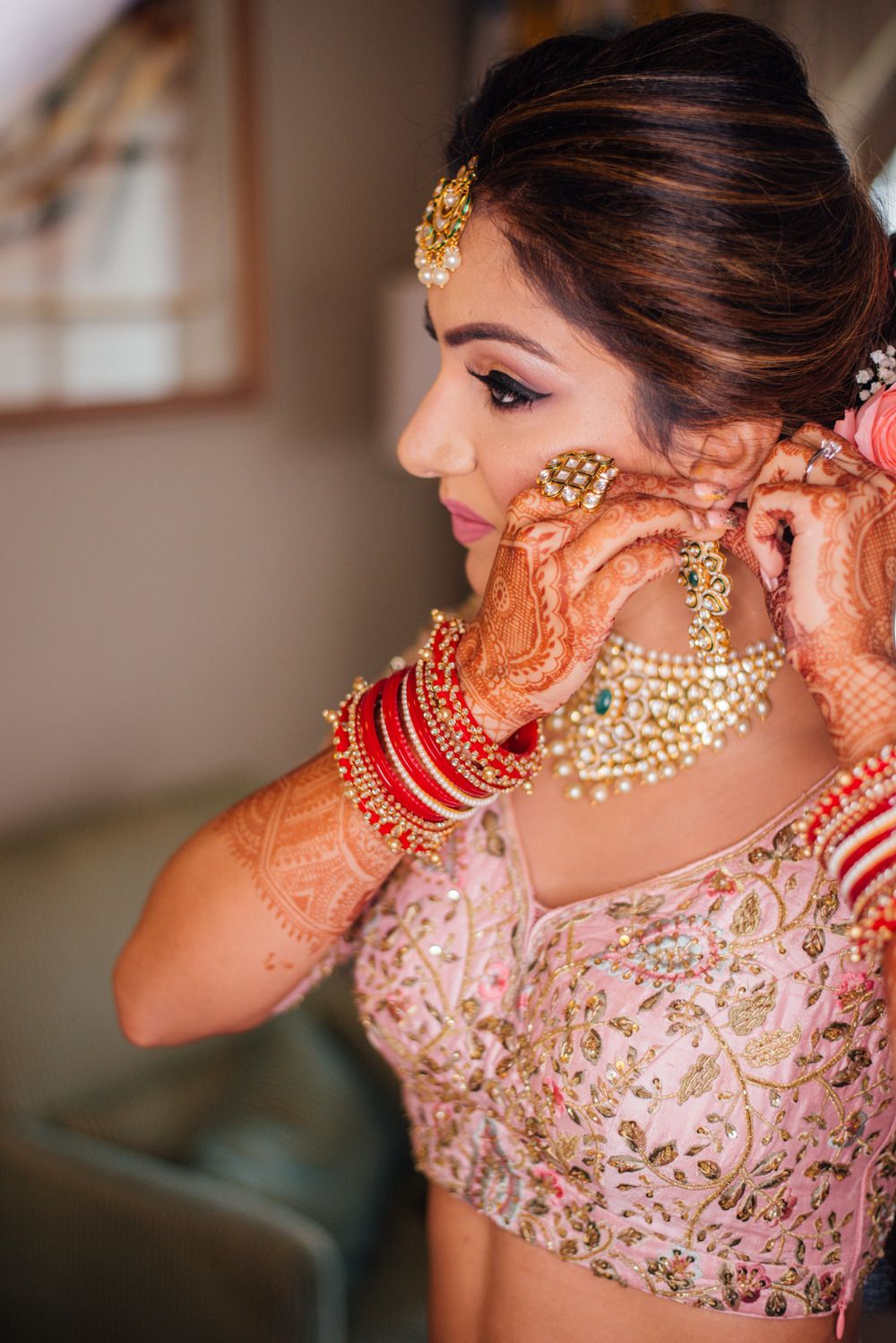 Photo of Bride wearing earring getting ready shot