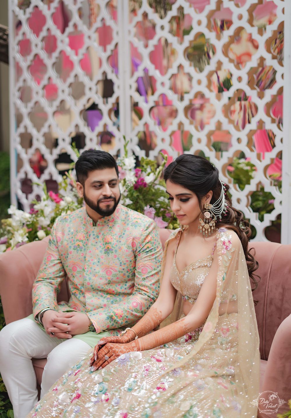 Photo of bride and groom on mehendi in all pastel looks