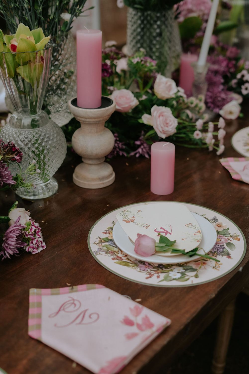 Photo of Gorgeous pink and white table setting with floral and candle elements