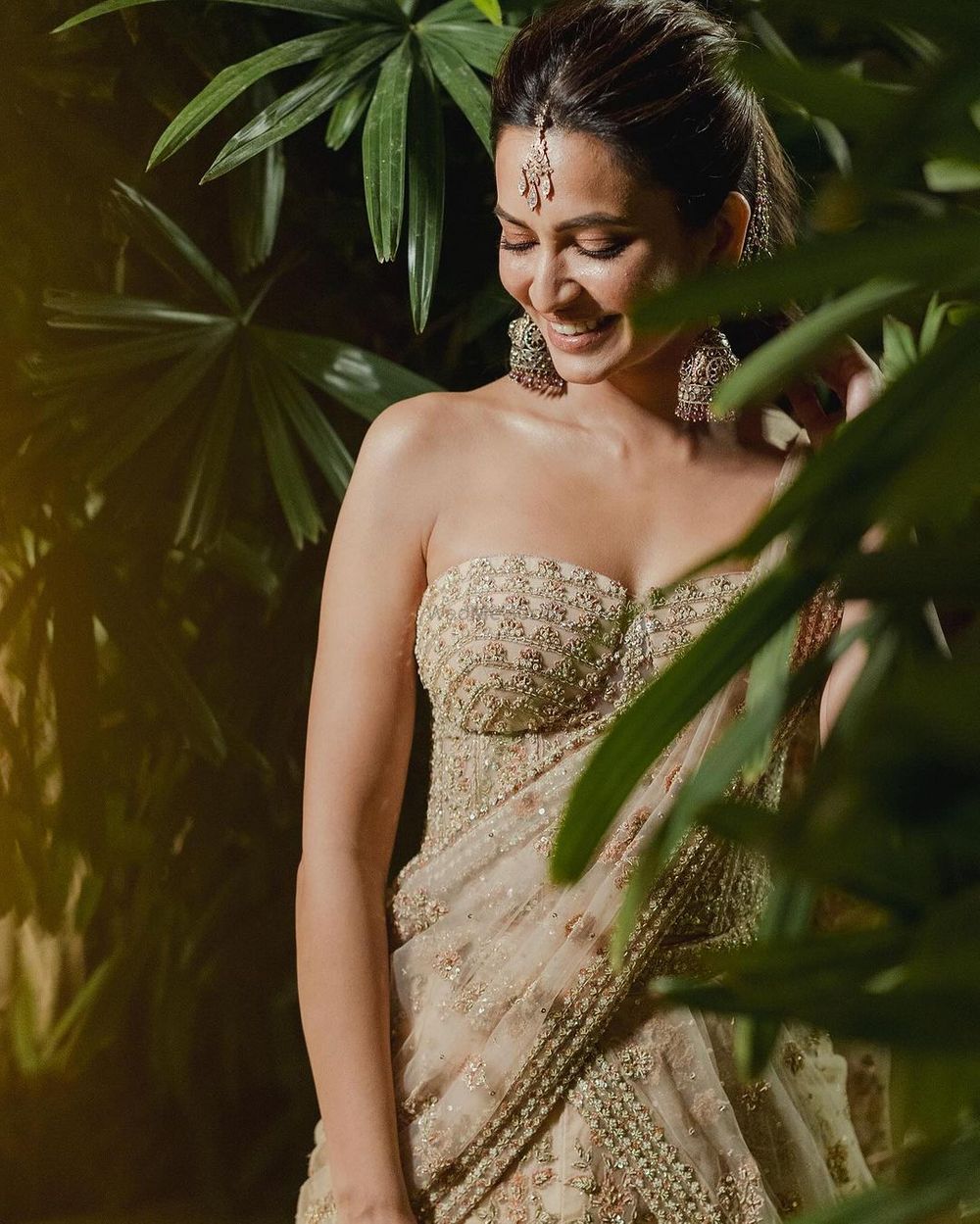 Photo of Stunning gold strapless saree gown with statement jhumkis for the mehendi