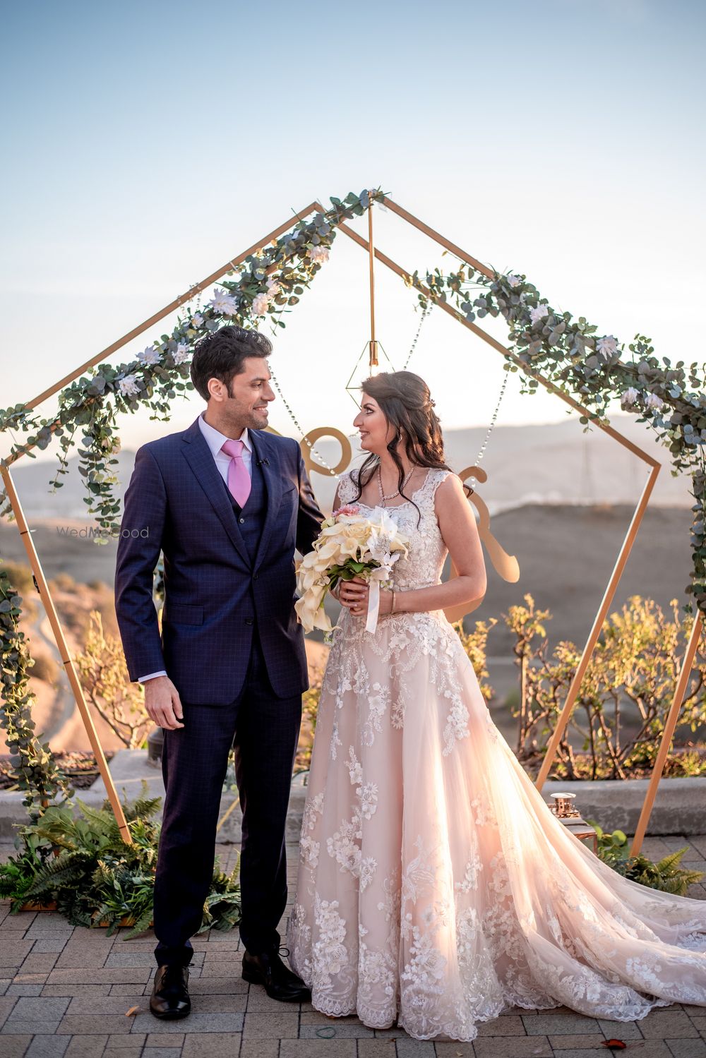 Photo of A candid shot of bride and groom looking at each other.