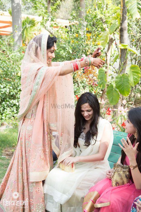 Photo of pale blush colored lehenga with mint detailing for morning wedding