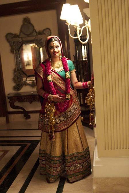 Photo of gold brocade bridal lehenga with a teal blouse and red dupatta
