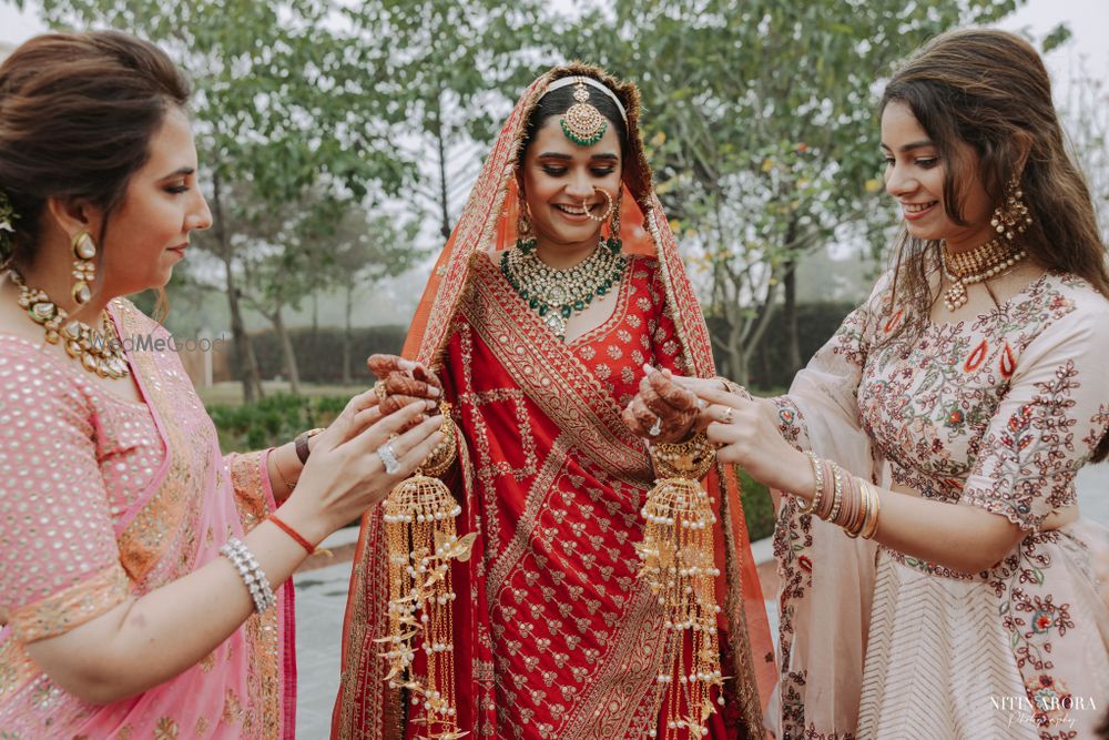 Photo of bridesmaids helping bride