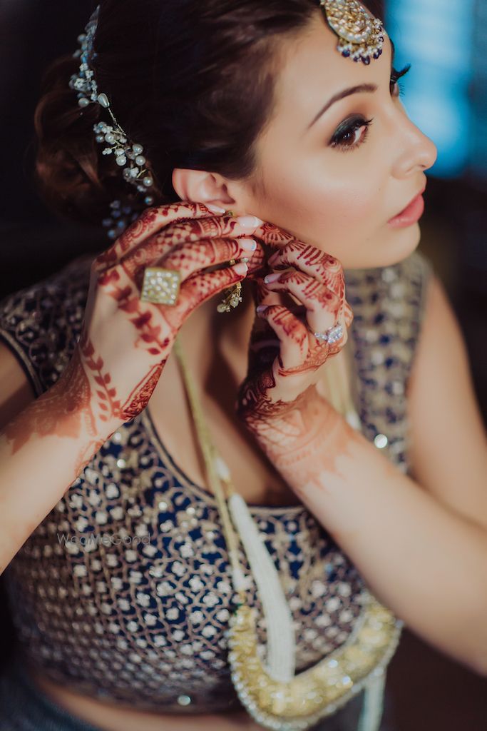 Photo of Bride getting ready shot wearing earrings