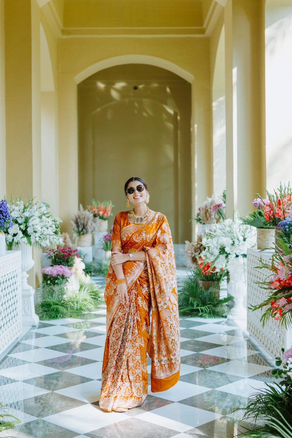Photo of Bride in an orange saree for the mehndi