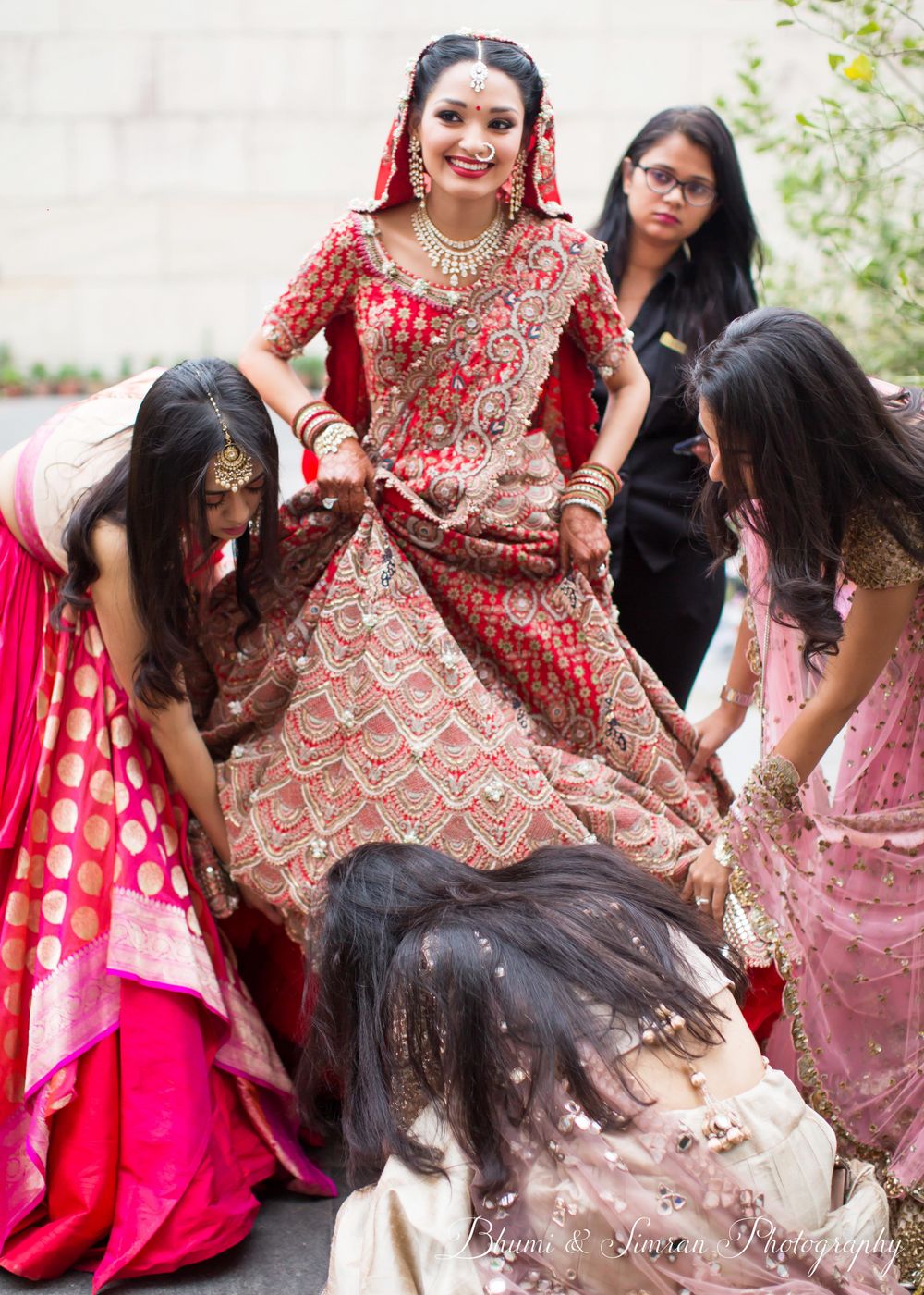 Photo of A bride in a goofy moment with her bridesmaids