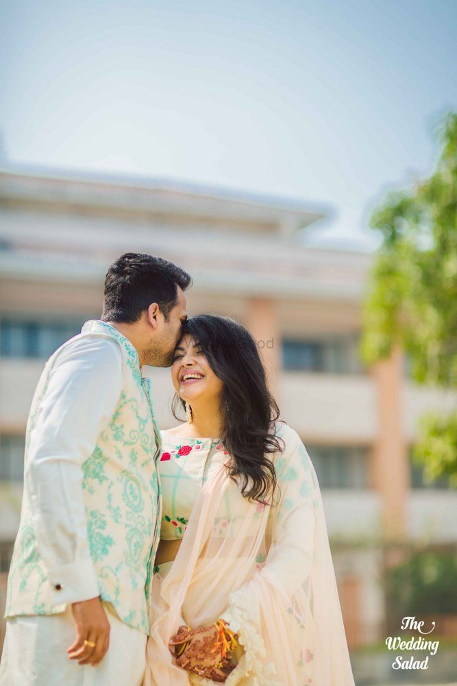 Photo of Bride and groom in color coordinated pastel outfits