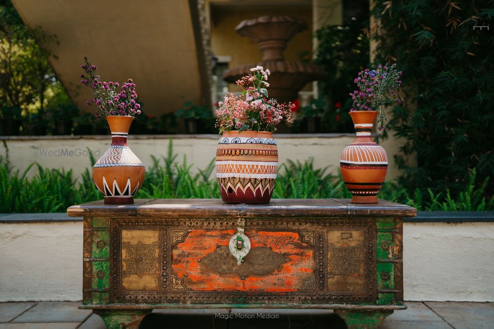 Photo of Fun use of terracotta vases with hand painted details and wild flowers