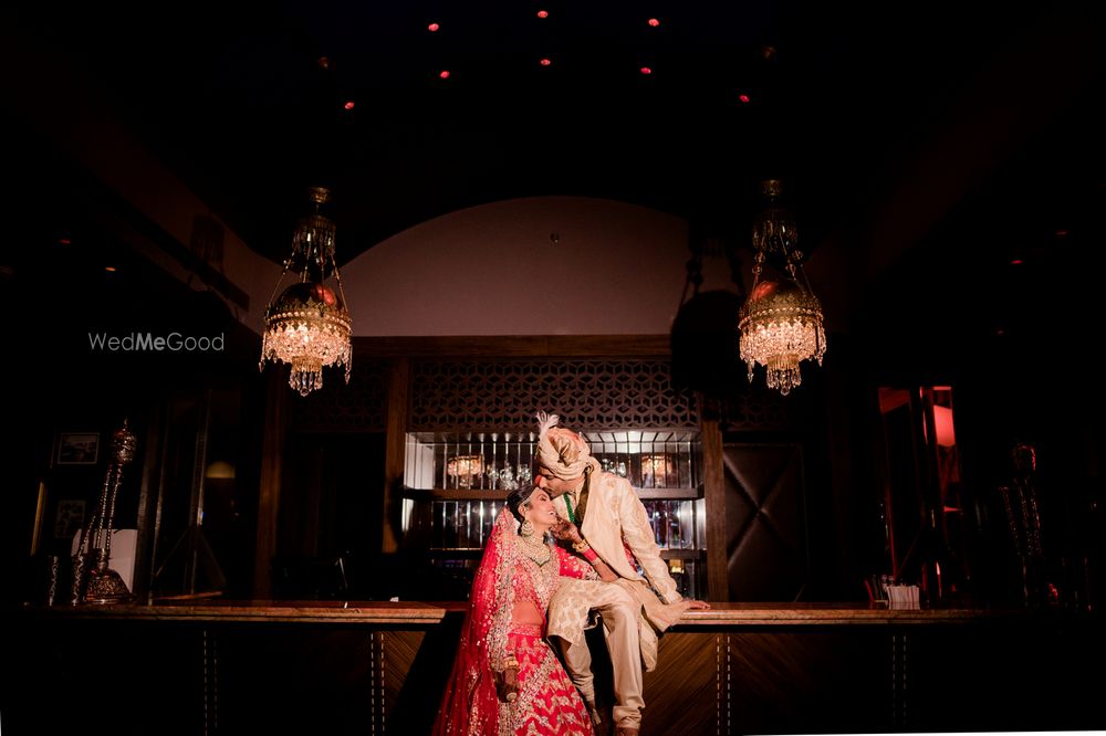 Photo of A cute couple portrait with the groom kissing bride's forehead