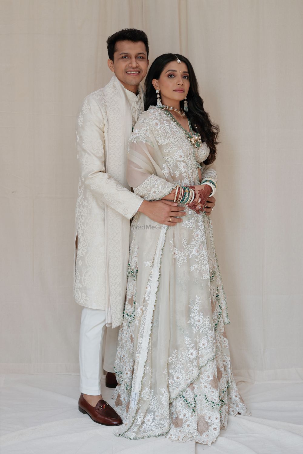 Photo of Beautiful all-ivory colour co-ordinated couple, posing just before their wedding day