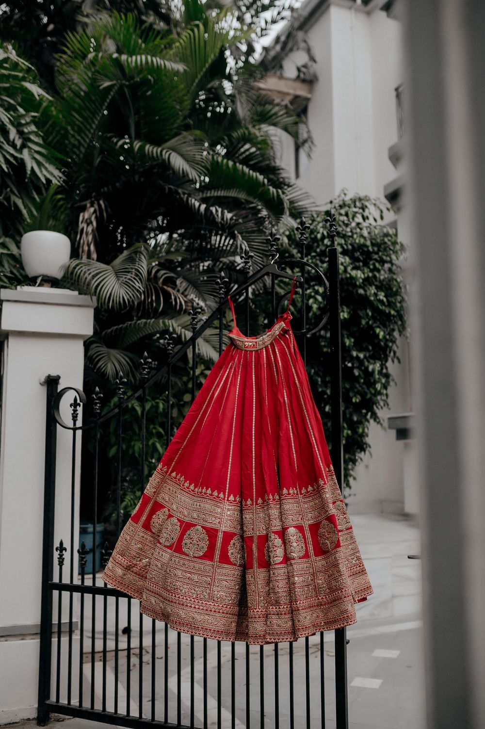 Photo of Red bridal lehenga on a hanger