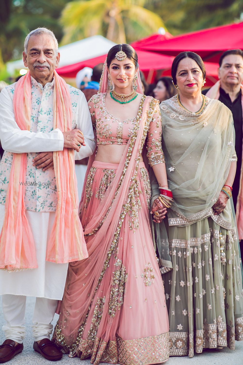 Photo of The bride entering with her mom and dad.