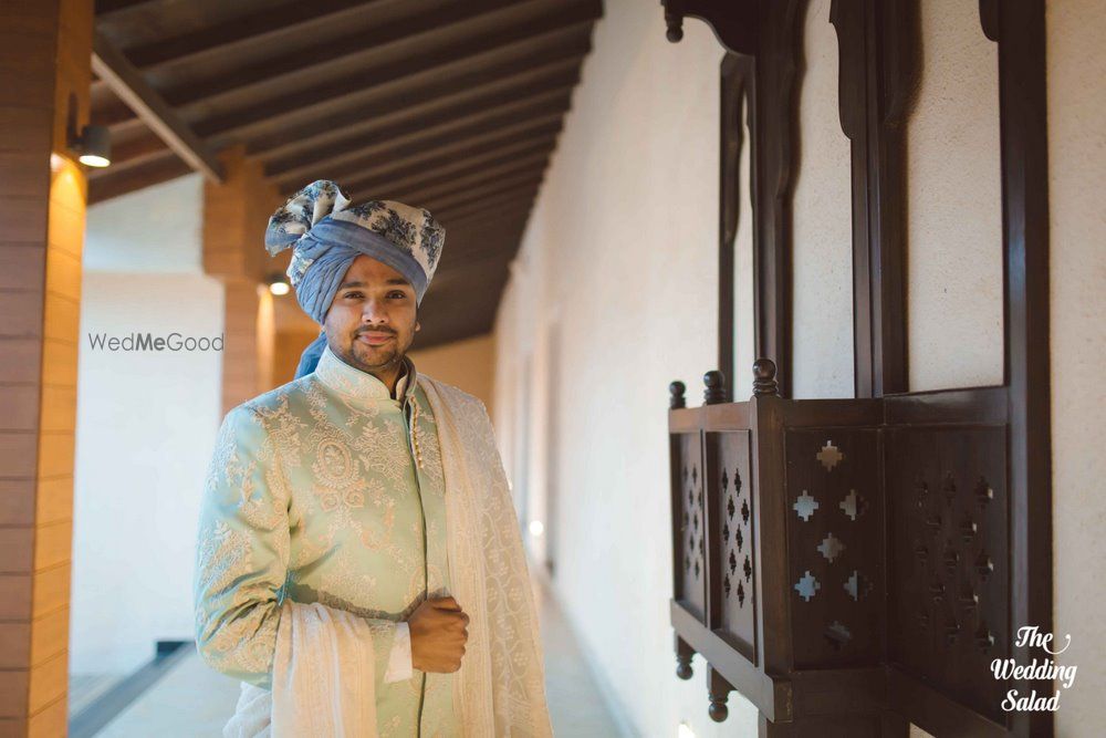 Photo of paste blue sherwani with floral print safa