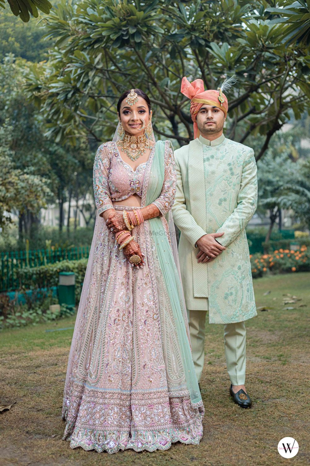 Photo of modern day wedding bride and groom looks in pastel outfits