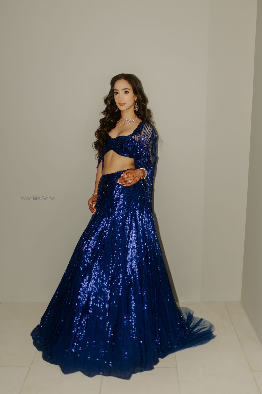Photo of Super glam shimmery electric blue lehenga for the sangeet night with a cape dupatta and open hair