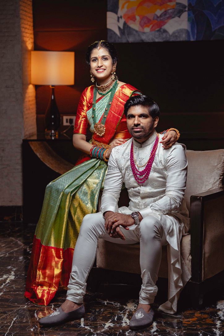 Photo of south indian couple shot with bride in green and rust kanjivaram