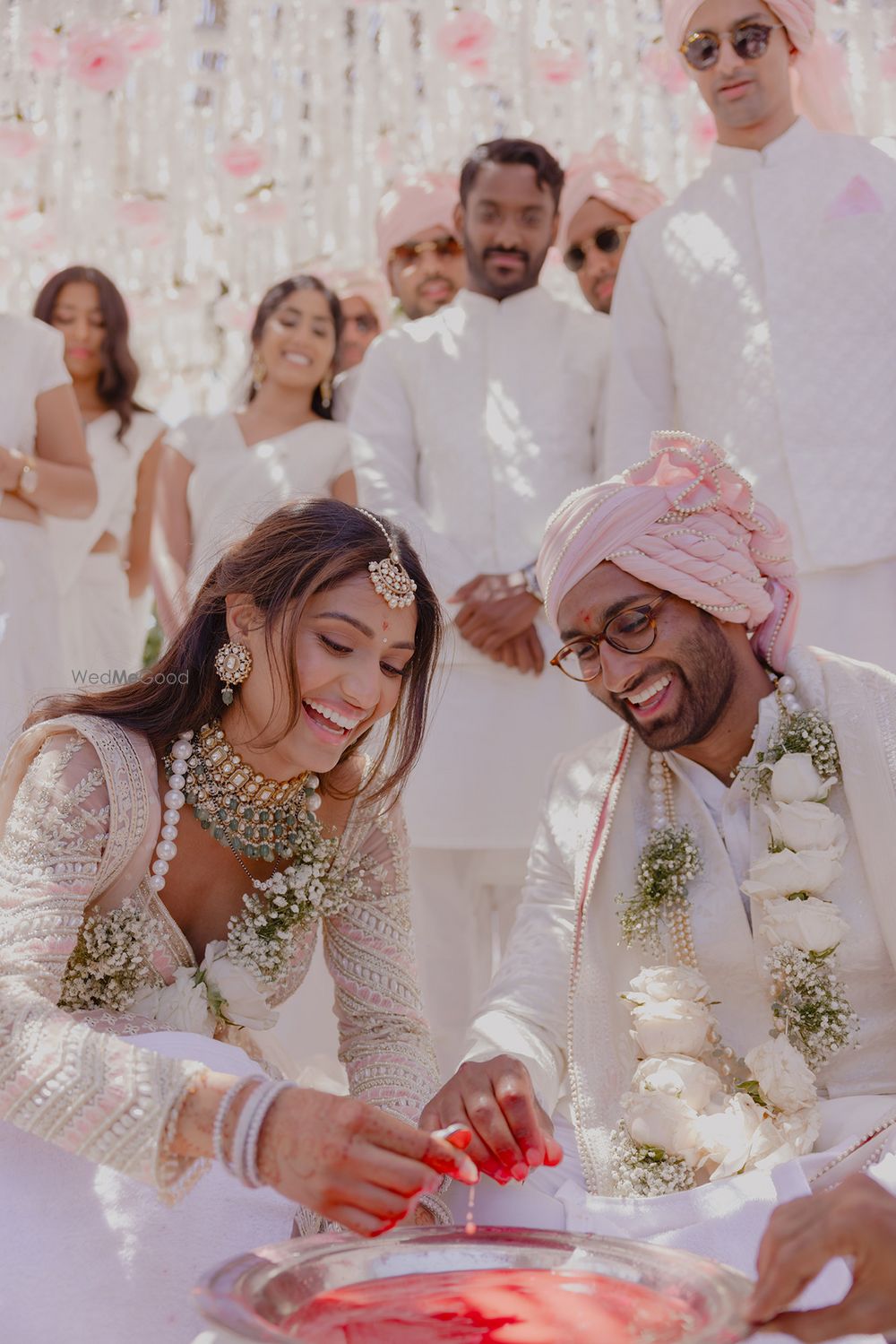 Photo of Candid couple portrait as they play wedding games on their wedding day with co-ordinated outfits