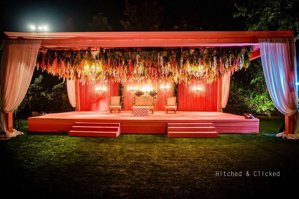 Photo of unique jaimala stage with hanging floral decor in peach theme
