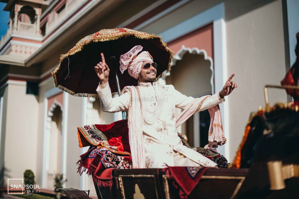 Photo of Dancing groom entering on a chariot.