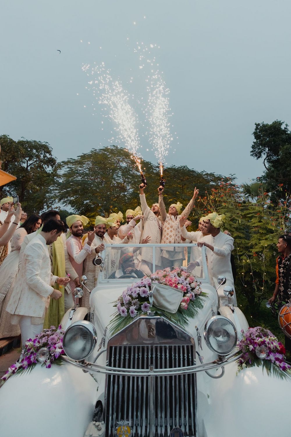 Photo of Sparkler gun entry for the groom and the baraatis in a vintage car