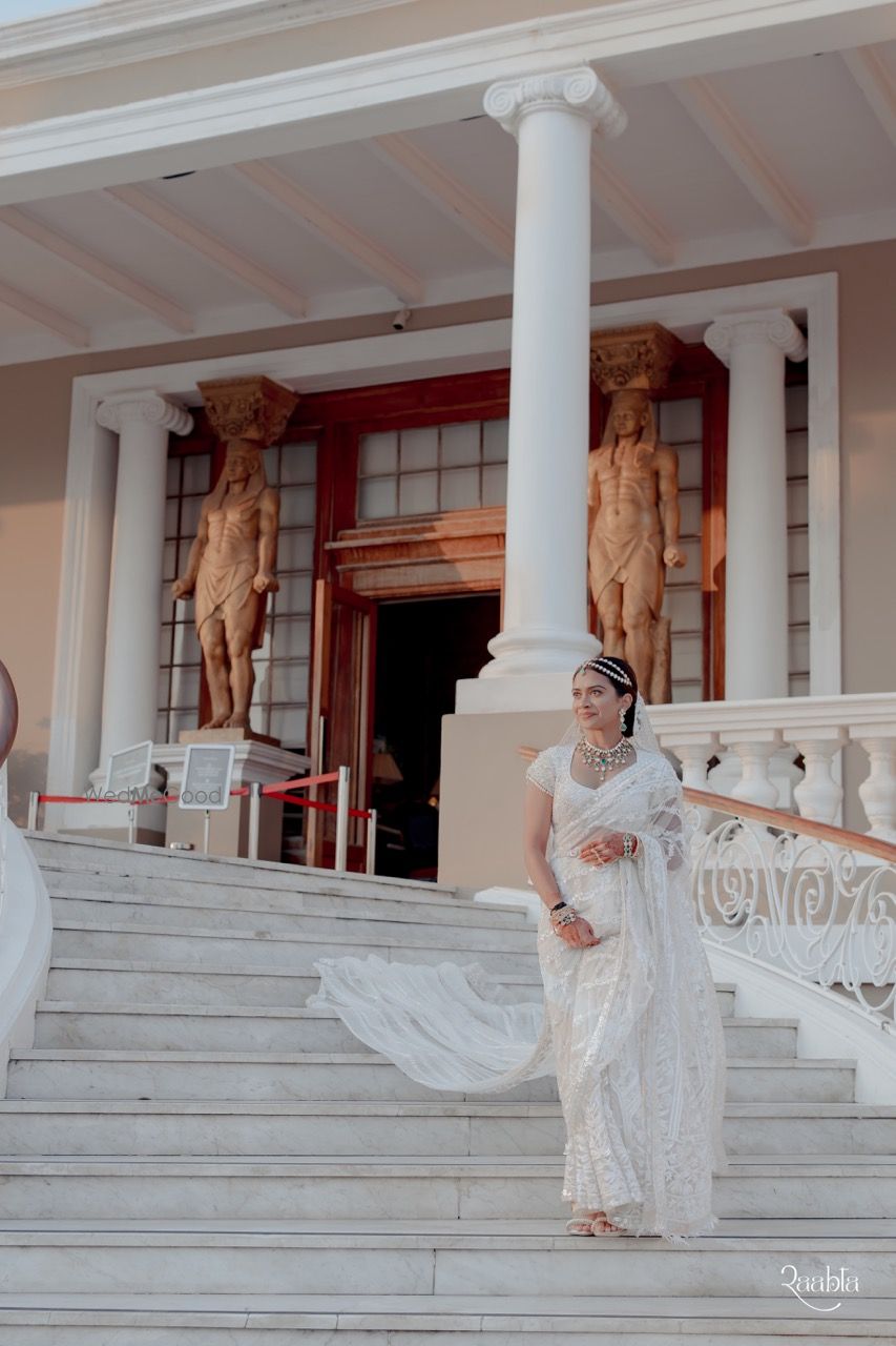 Photo of Bride entering the wedding venue in an all-white bridal saree and diamond jewellery