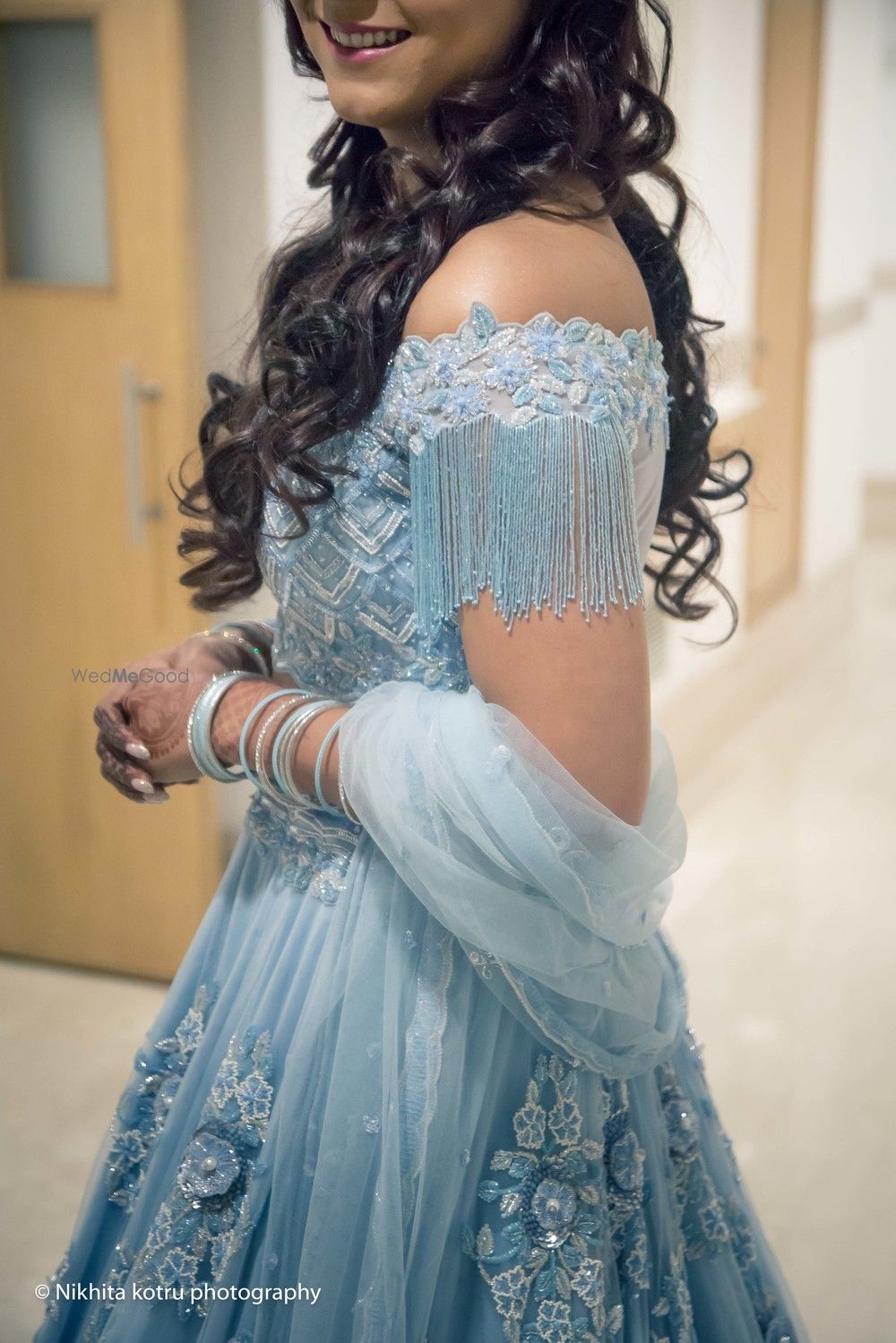 Photo of Light blue engagement lehenga with tassels on sleeve