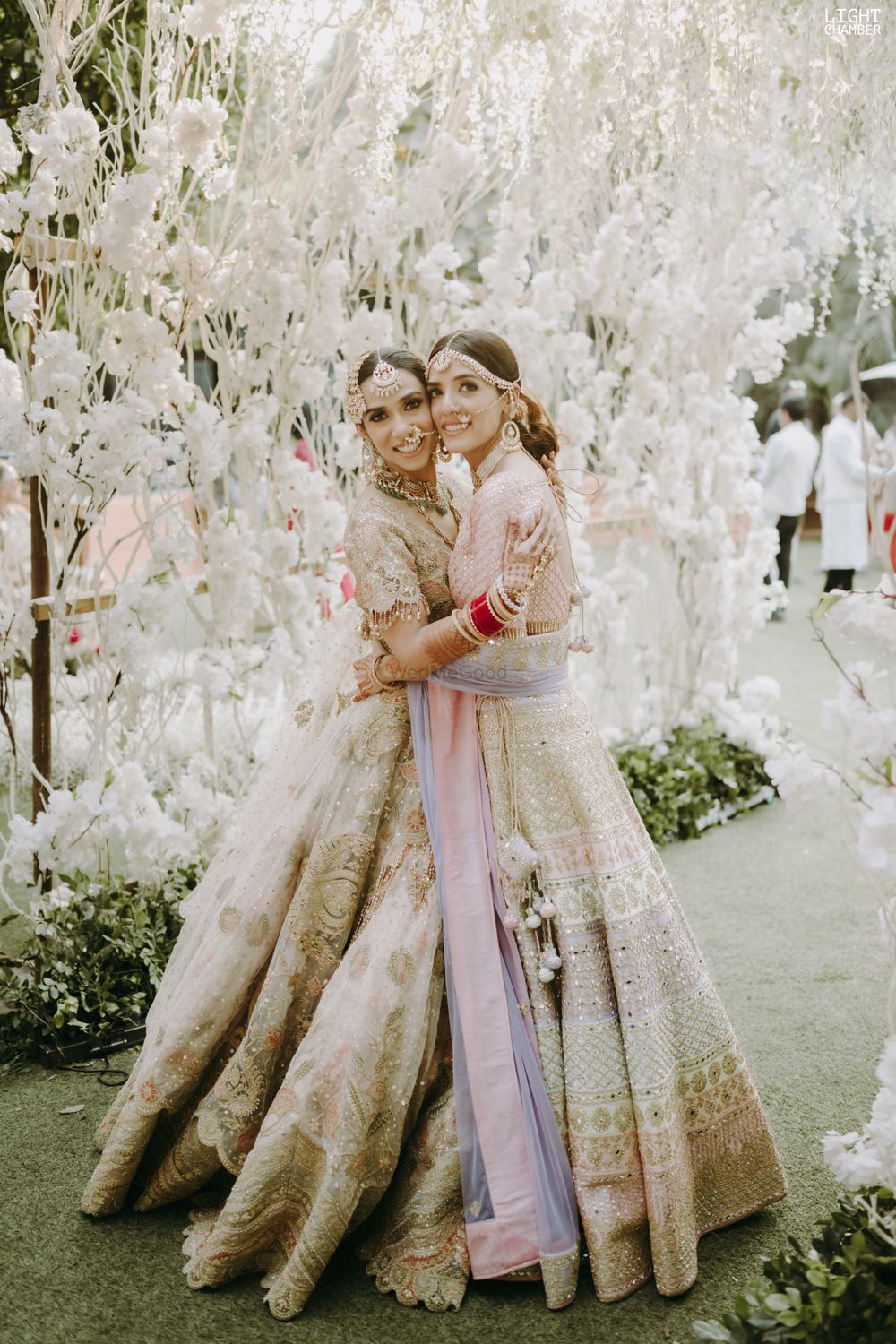 Photo of pretty bride and bridesmaid duo in pastel lehengas