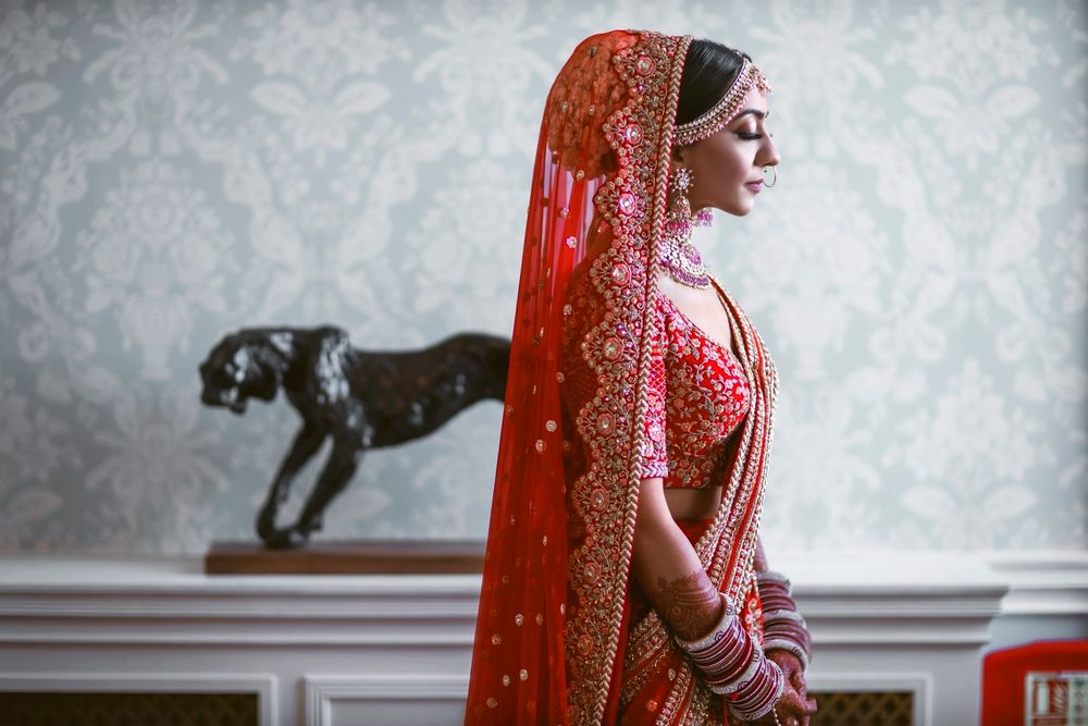 Photo of Bride dressed in a red lehenga.