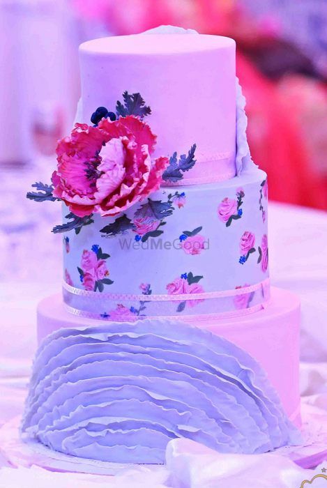 Photo of elegant whimsical cake with floral print tier