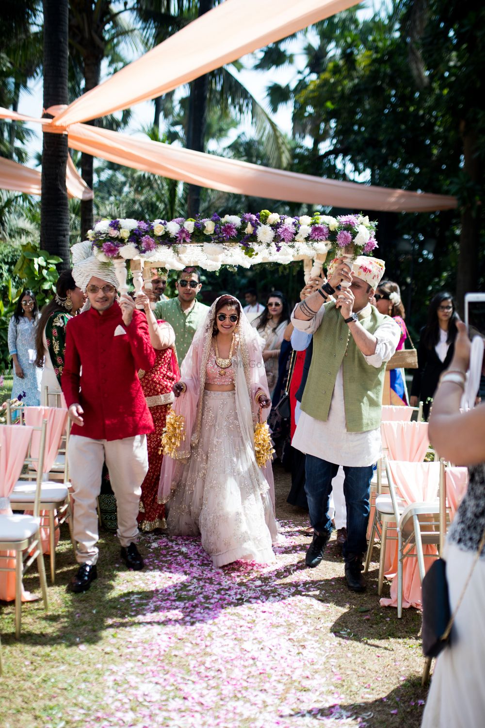 Photo of The bride entering with her brothers under a gorgeous phoolon ki chaadar