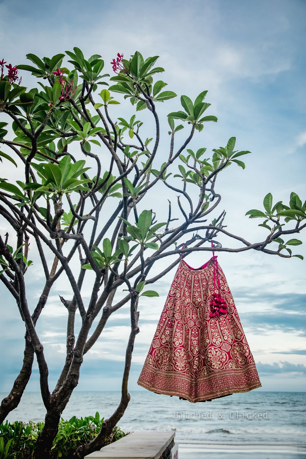 Photo of Red bridal lehenga on a hanger shot