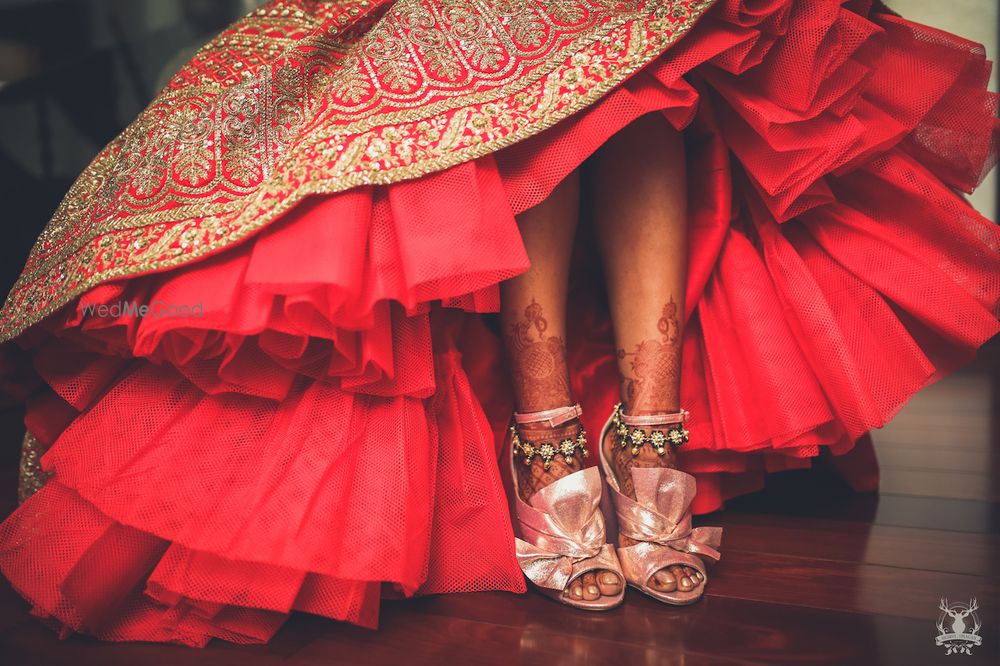 Photo of Red bridal lehenga with can can and unique shoes