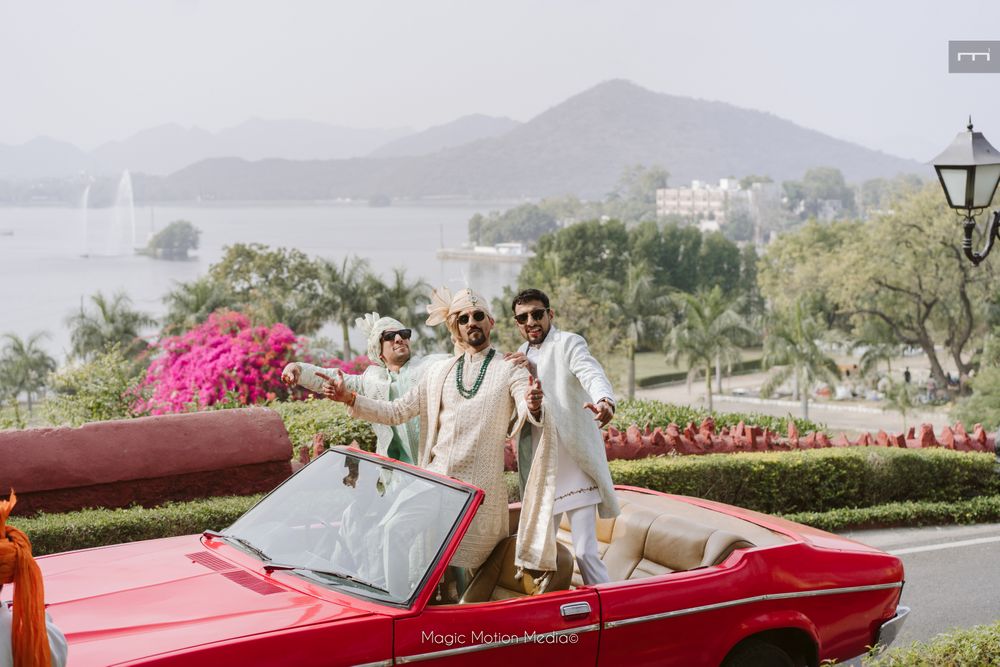 Photo of Groom and his baraat entering in a fun vintage red car