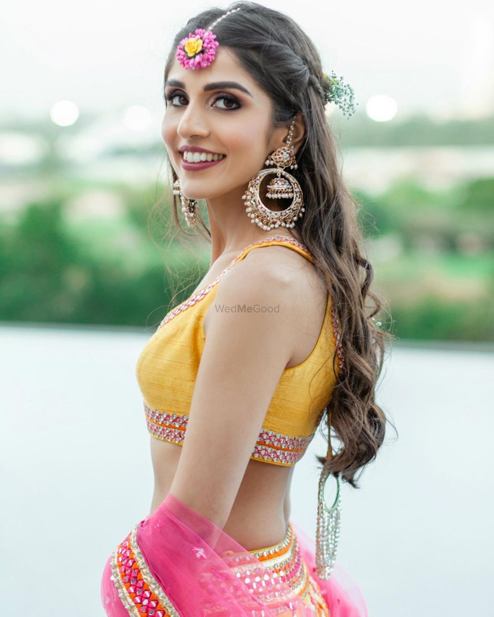 Photo of Bride wearing huge chaand baali earrings.