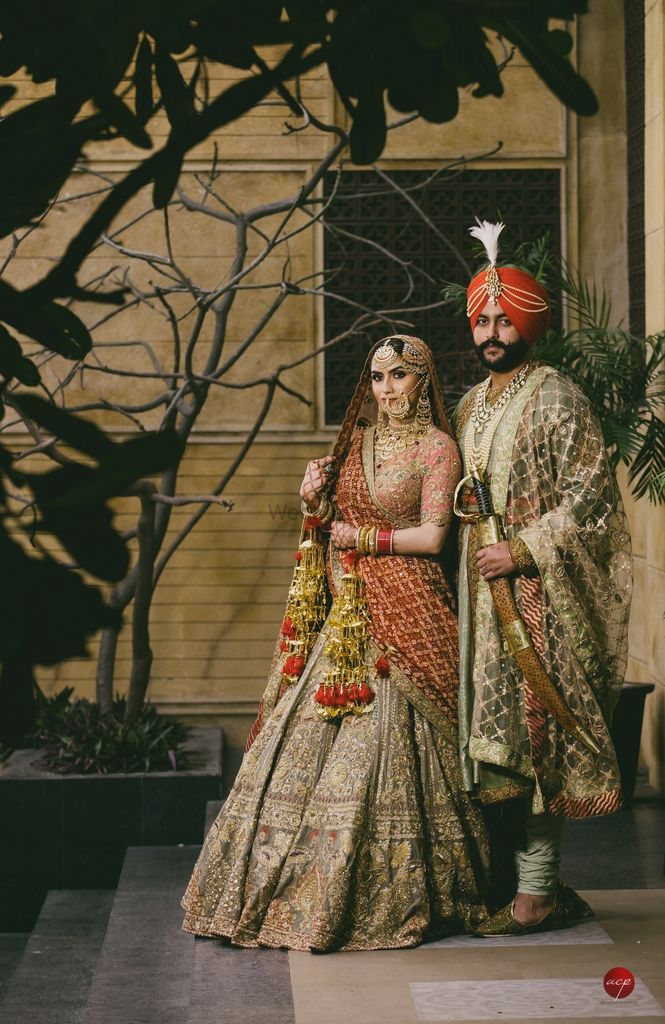 Photo of A sikh bride and groom in coordinated vintage outfits