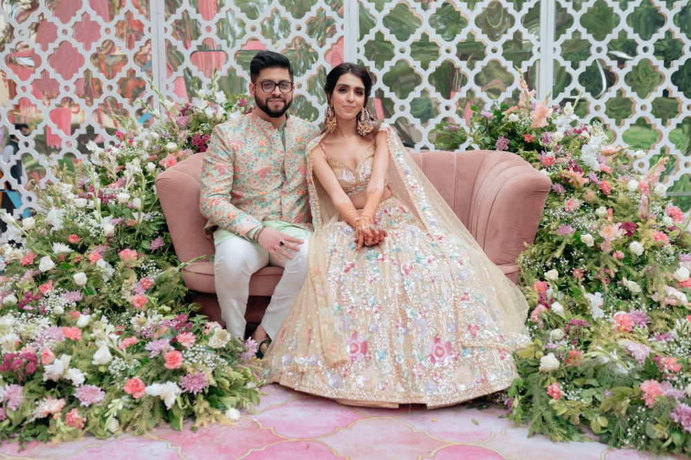 Photo of mehendi couple portrait with all pastel decor and outfits