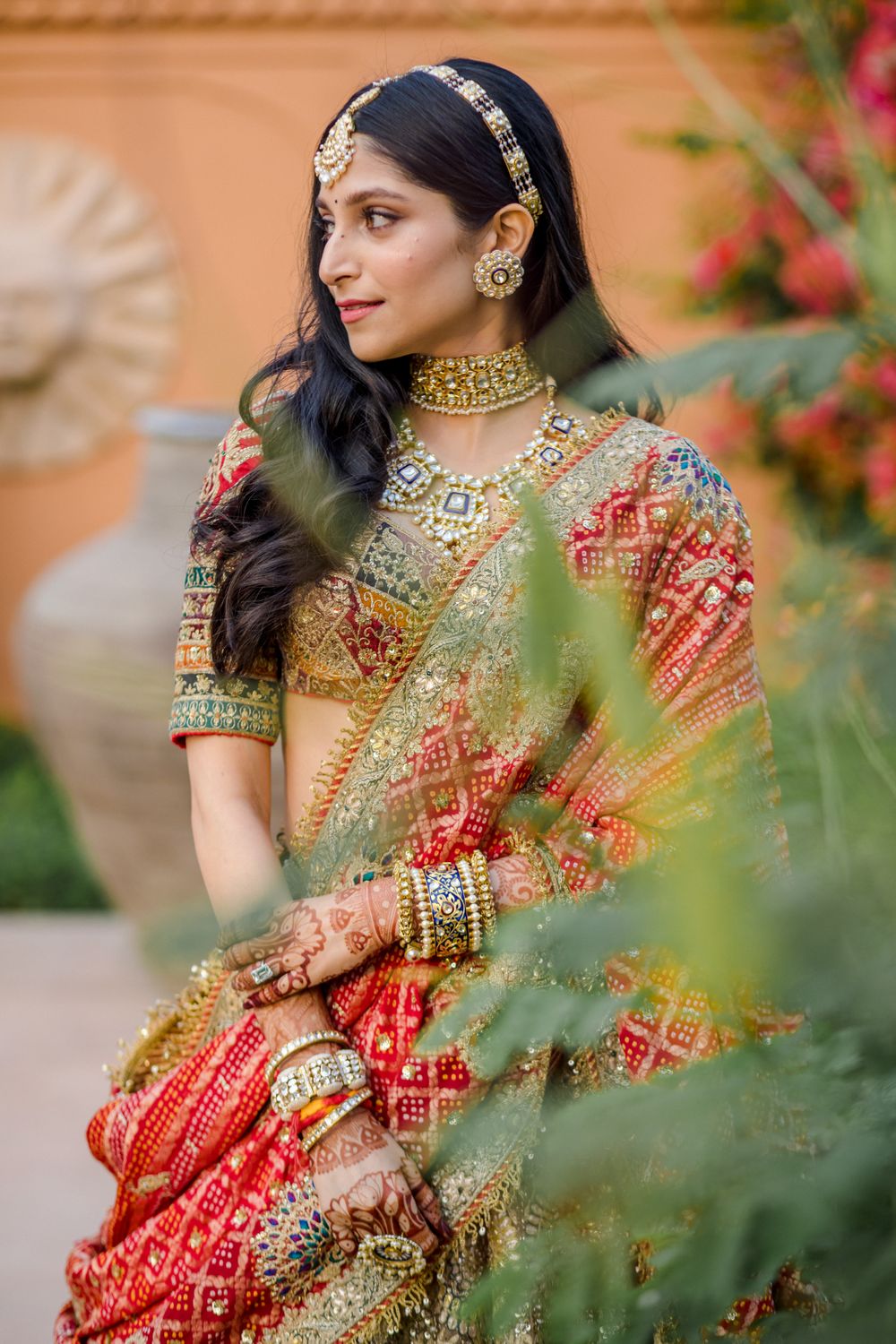 Photo of Bride wearing a multi-coloured lehenga on her wedding day.