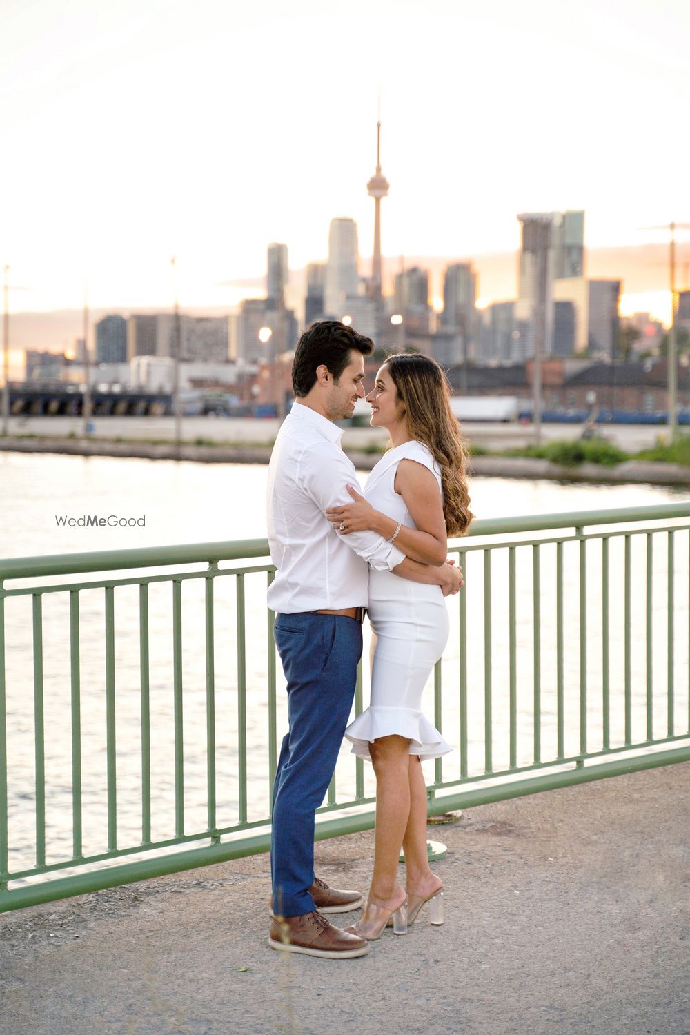 Photo of couple wearing matching white outfits for their pre wedding shoot