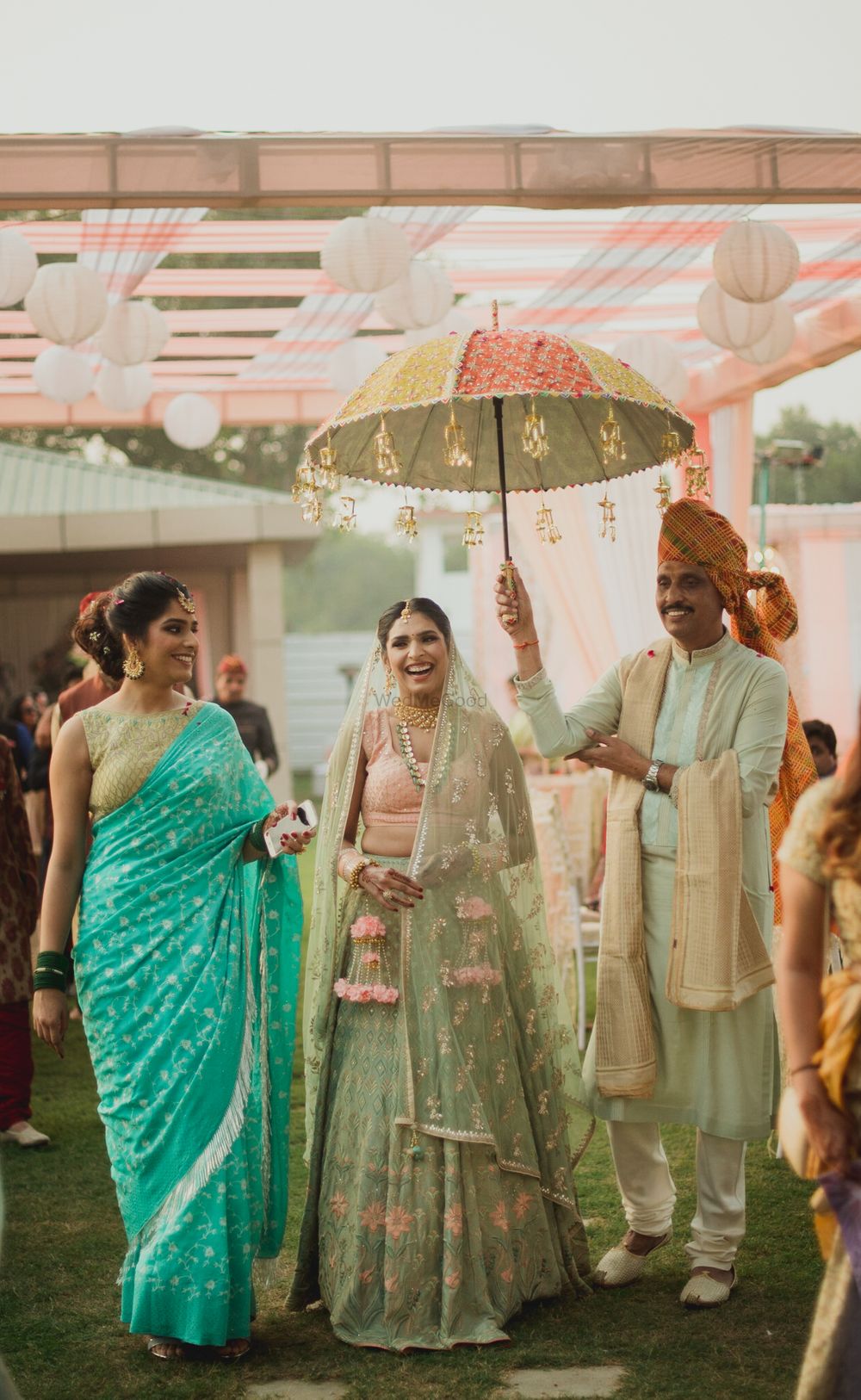 Photo of Unique bridal entry pastel wedding under umbrella