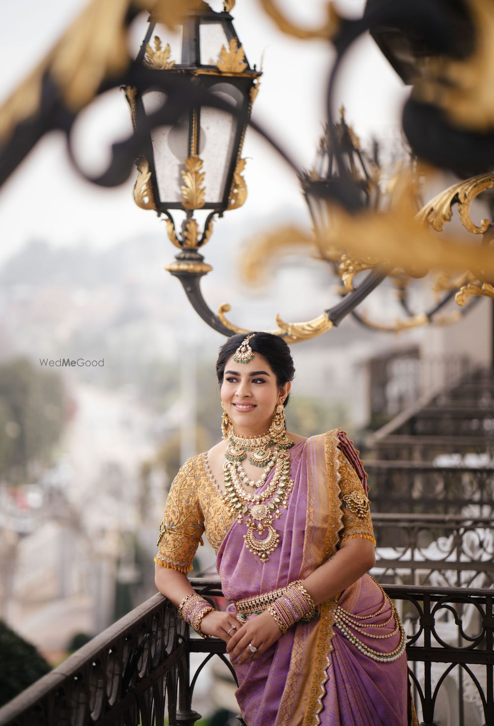 Photo of Lovely bridal portrait with the bride in a lavender and gold saree and stunning south indian jewels