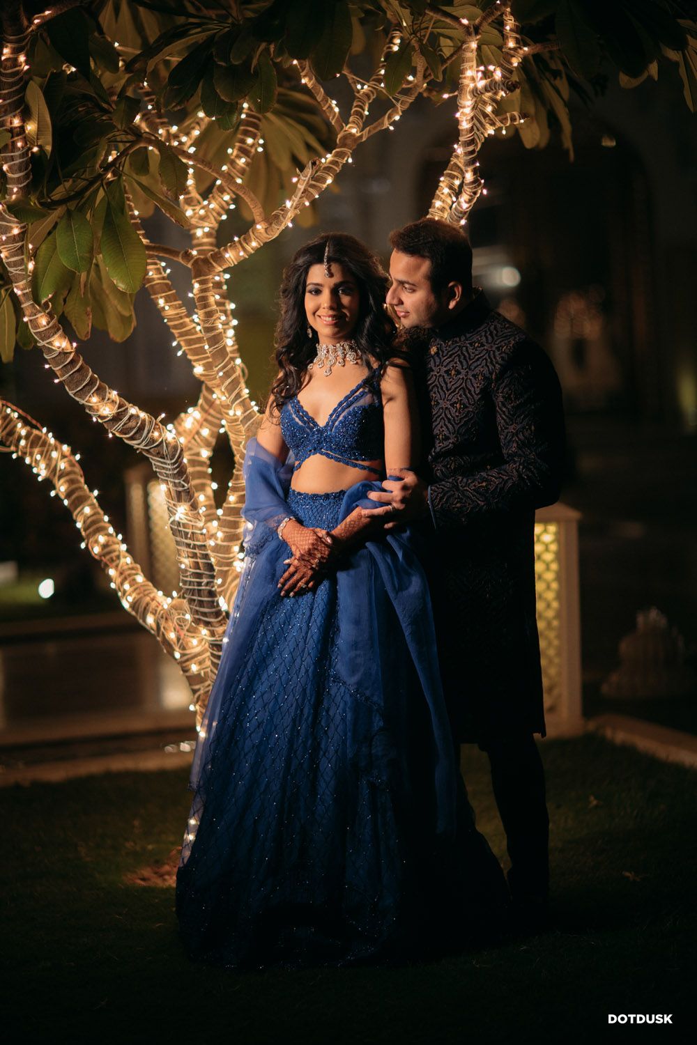 Photo of A romantic couple portrait in front of fairy lights decor