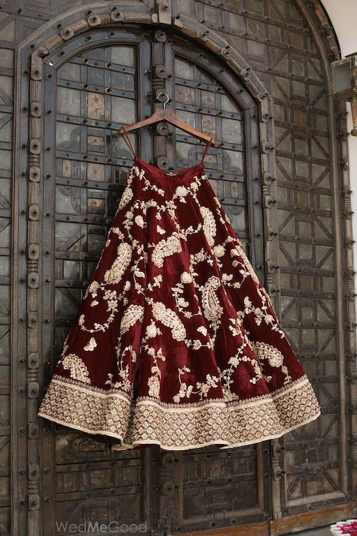 Photo of Winter wedding maroon lehenga on hanger