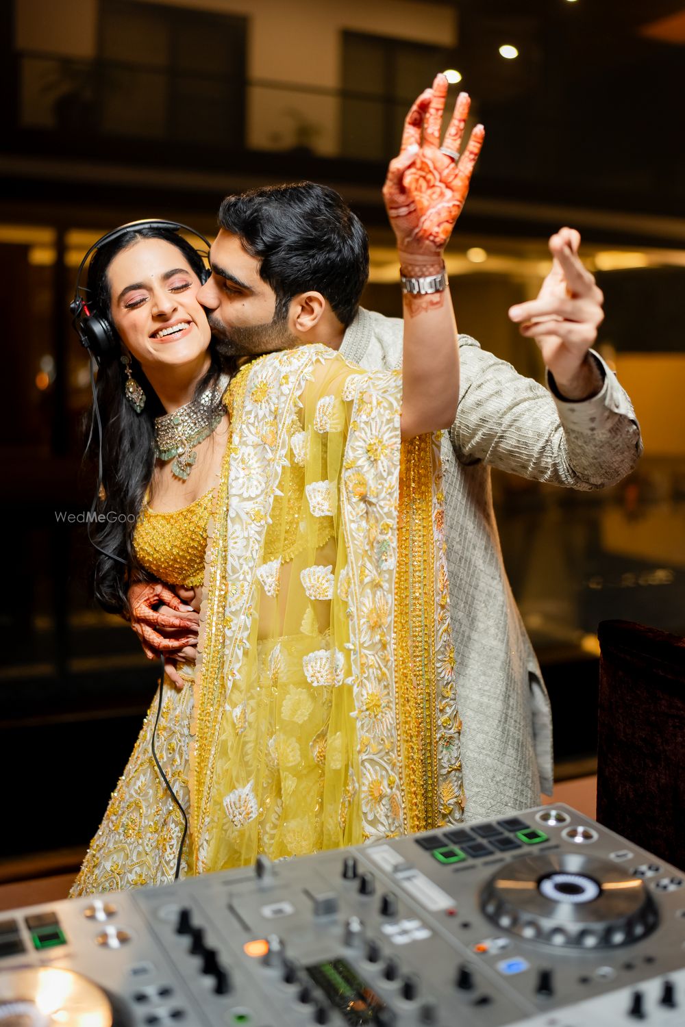 Photo of The couple having fun at their mehendi party at the DJ station