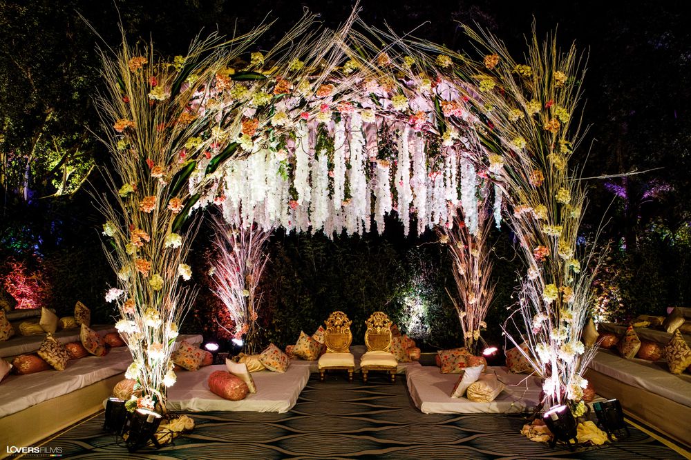 Photo of A mandap decorated with flowers and pampas grass.